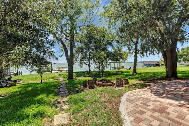 view of yard with a water view and a patio