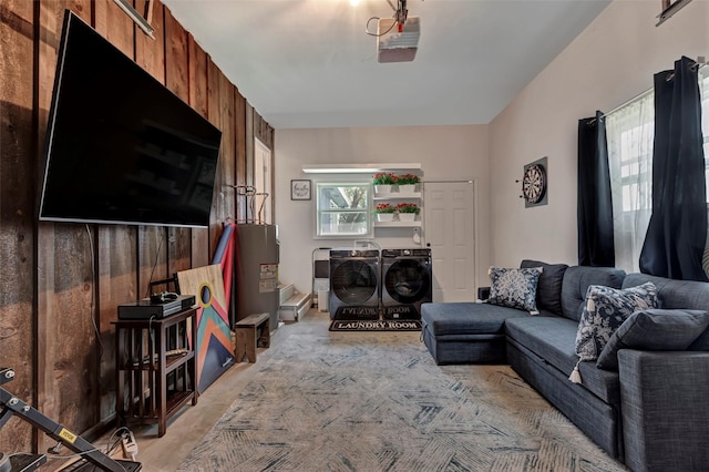 living room with separate washer and dryer and electric water heater