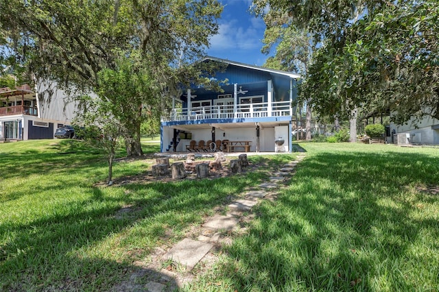 354 Edgewater Way, Point Blank, TX 77364 - rear view of house featuring ceiling fan, a lawn, and a balcony
