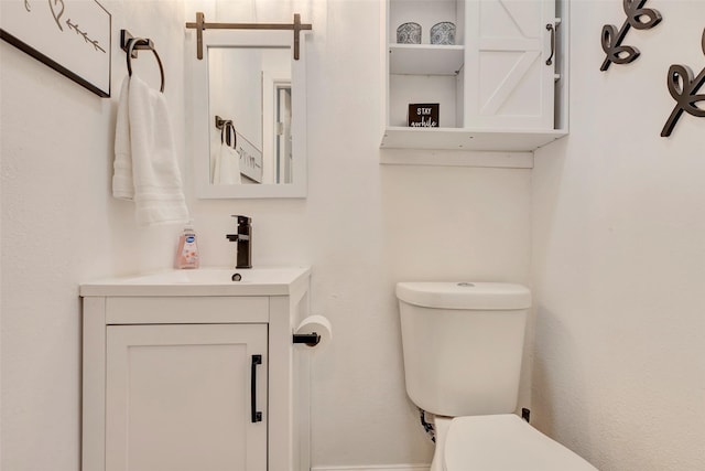 bathroom with toilet and vanity