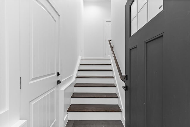 stairway with tile patterned floors