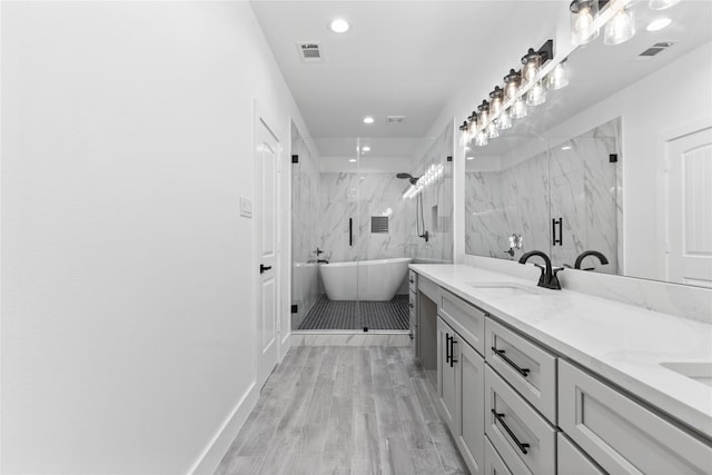 bathroom with tile walls, plus walk in shower, wood-type flooring, and vanity