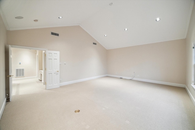 spare room with light carpet, crown molding, and high vaulted ceiling