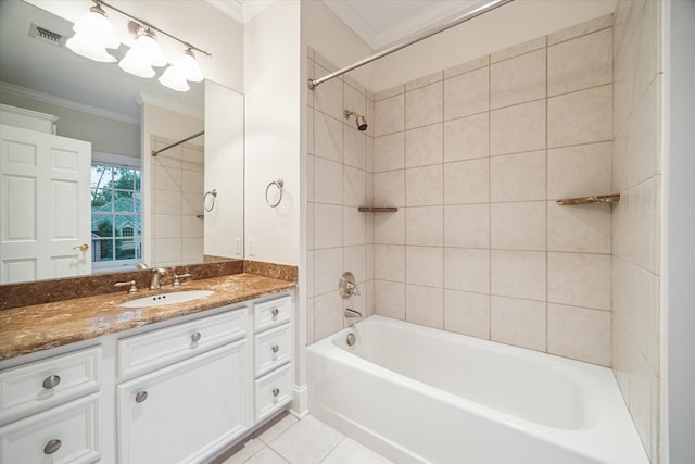 bathroom featuring vanity, ornamental molding, tiled shower / bath, and tile patterned flooring