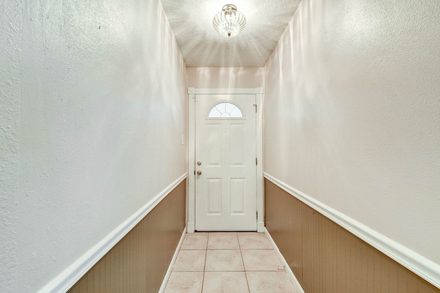 doorway with light tile patterned floors