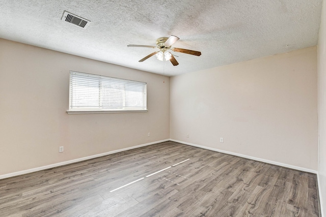 unfurnished room featuring ceiling fan, light hardwood / wood-style flooring, and a textured ceiling