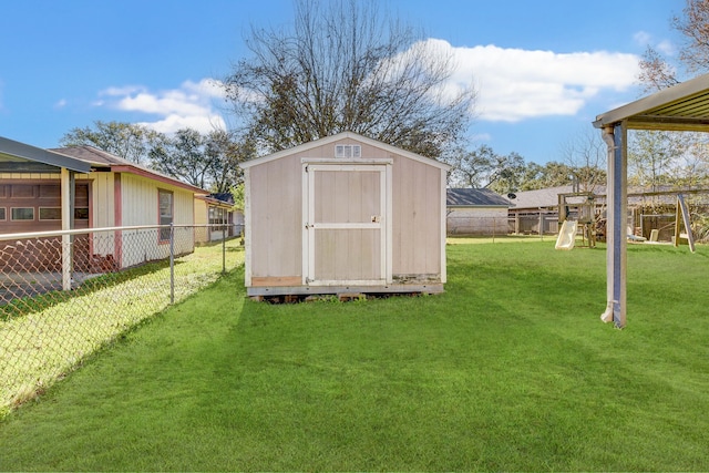 view of outbuilding with a yard and a playground