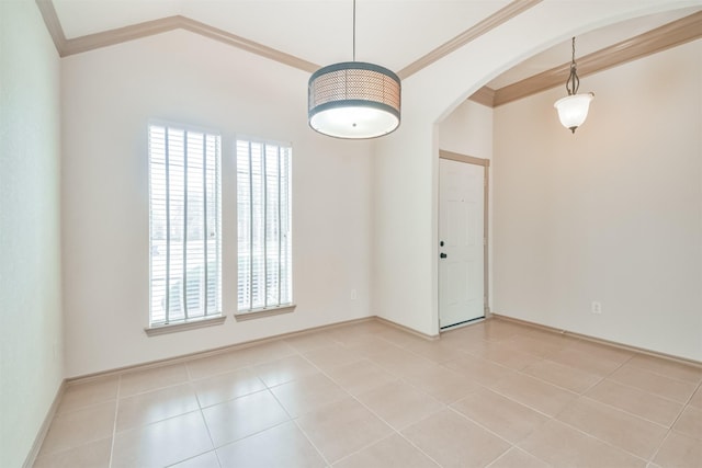 tiled spare room featuring crown molding, vaulted ceiling, and a wealth of natural light