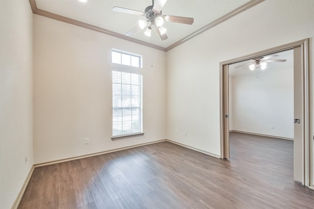 spare room featuring crown molding, hardwood / wood-style floors, and ceiling fan