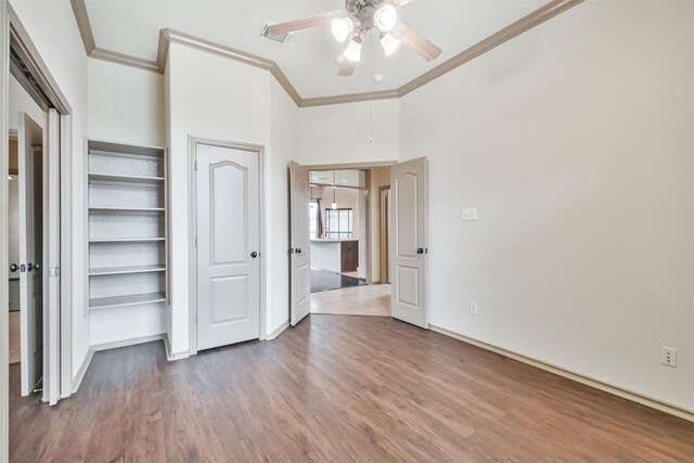 unfurnished bedroom featuring crown molding, ceiling fan, and wood-type flooring