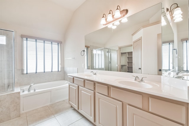 bathroom with vaulted ceiling, vanity, independent shower and bath, and tile patterned flooring