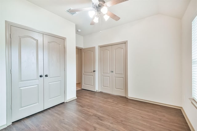 unfurnished bedroom with vaulted ceiling, ceiling fan, and light hardwood / wood-style floors