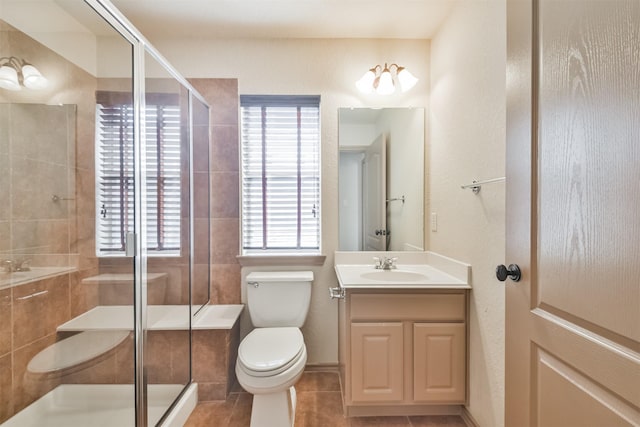 bathroom with an enclosed shower, vanity, tile patterned flooring, and toilet