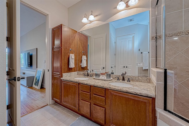 bathroom with tile patterned flooring, vanity, a chandelier, and walk in shower