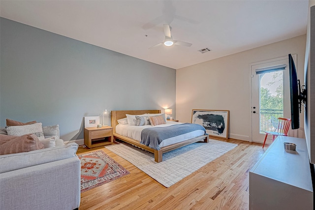 bedroom with ceiling fan, access to exterior, and light wood-type flooring