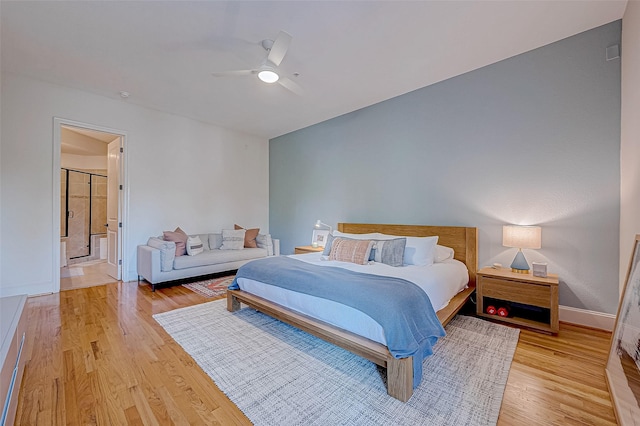 bedroom with connected bathroom, ceiling fan, and light hardwood / wood-style flooring