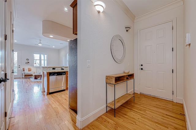 foyer with ceiling fan, light hardwood / wood-style flooring, and ornamental molding