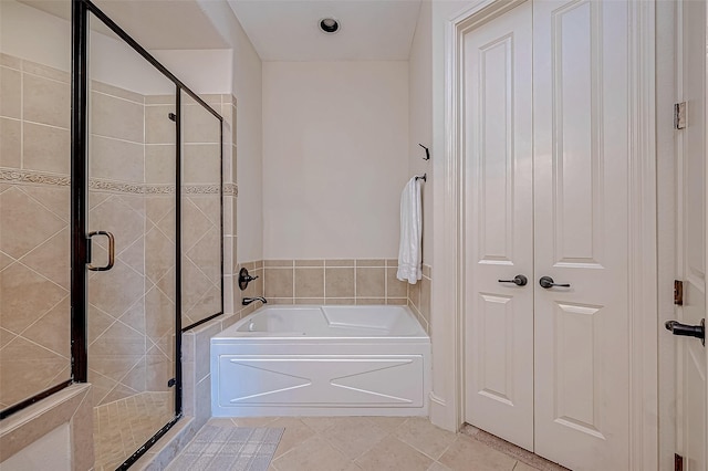 bathroom with tile patterned floors and shower with separate bathtub