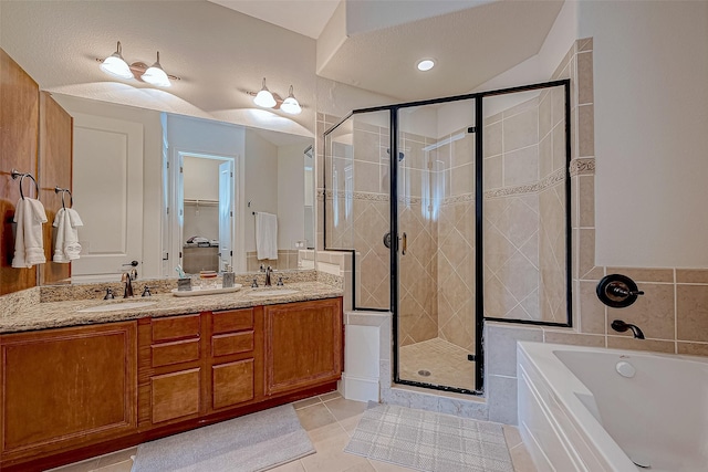 bathroom featuring tile patterned flooring, vanity, and independent shower and bath