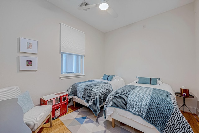 bedroom with hardwood / wood-style floors and ceiling fan