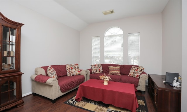 living room with dark wood-type flooring and vaulted ceiling