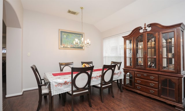 dining room with vaulted ceiling, a notable chandelier, and dark hardwood / wood-style floors