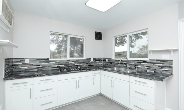 kitchen featuring sink, white cabinets, tasteful backsplash, and black gas stovetop