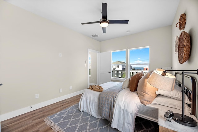 bedroom with ceiling fan and wood-type flooring