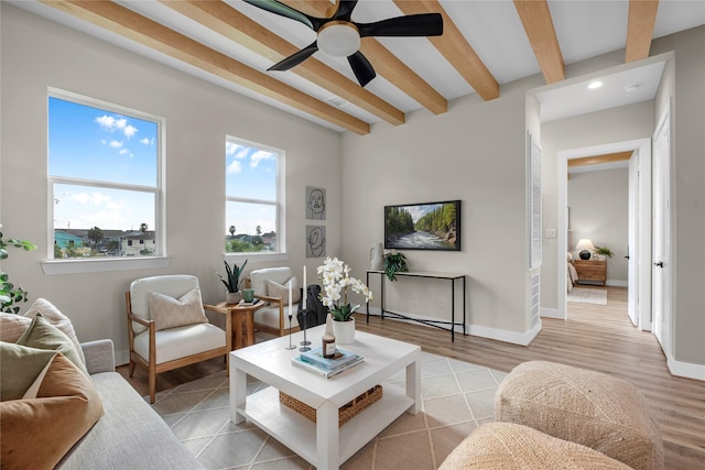 living room with beamed ceiling, ceiling fan, and light hardwood / wood-style flooring