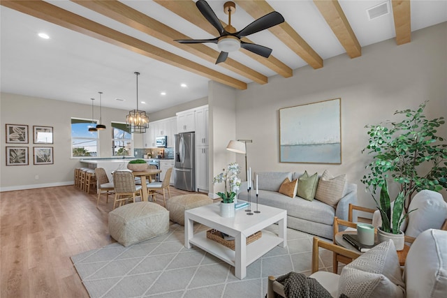 living room featuring ceiling fan, beamed ceiling, and light wood-type flooring