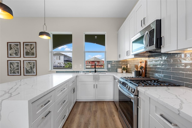 kitchen with white cabinets, stainless steel appliances, and sink