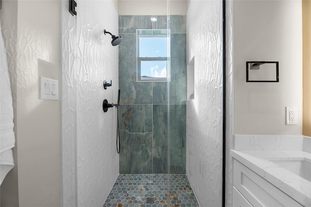 bathroom with a shower with door and vanity