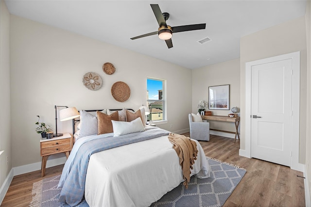 bedroom with light hardwood / wood-style floors and ceiling fan