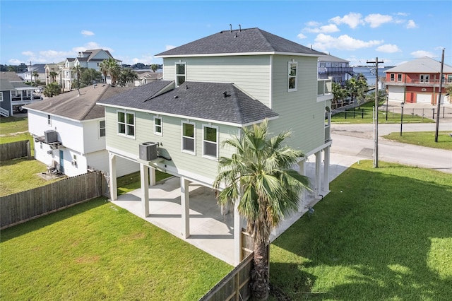 back of property featuring a patio, central AC unit, and a lawn