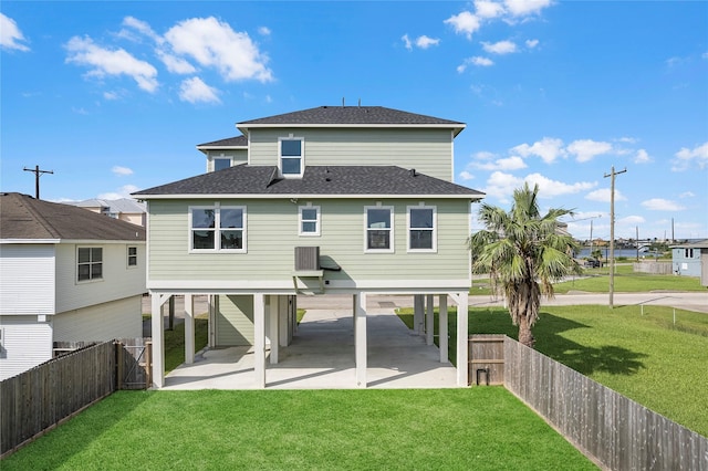 rear view of house with a lawn and a patio