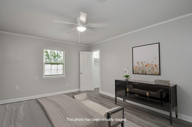 bedroom featuring ceiling fan, wood-type flooring, and crown molding