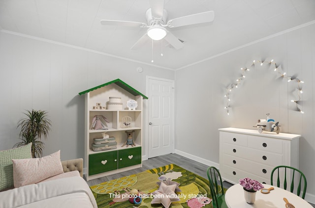 bedroom with crown molding, ceiling fan, and wood-type flooring