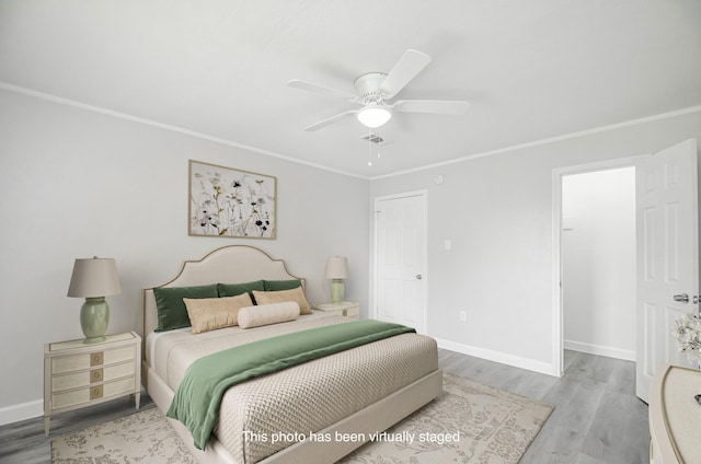 bedroom with hardwood / wood-style floors, ceiling fan, and ornamental molding