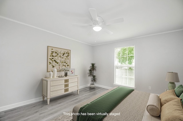 bedroom featuring ceiling fan, crown molding, and hardwood / wood-style flooring