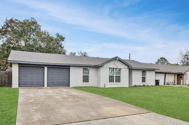 ranch-style home with a garage and a front lawn