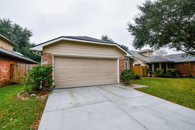 view of front of house featuring a garage and a front lawn