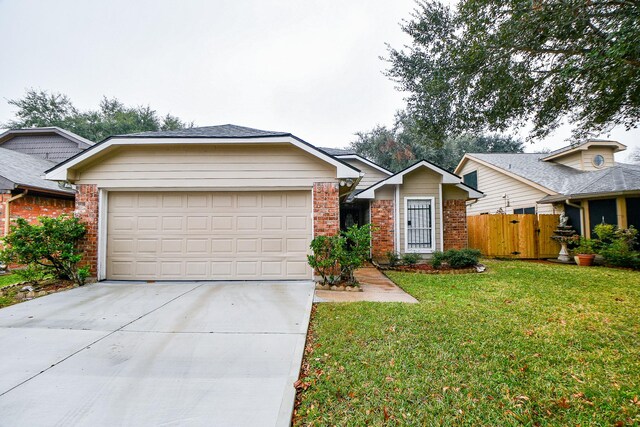 single story home featuring a front lawn and a garage