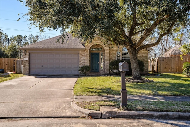 view of front of house featuring a garage and a front lawn