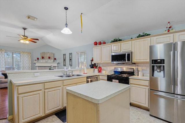 kitchen featuring backsplash, sink, a kitchen island, and stainless steel appliances