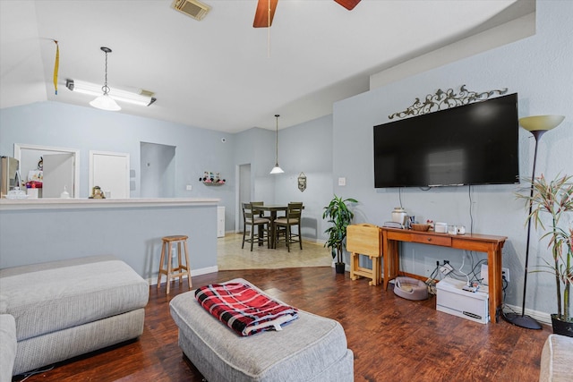 living room featuring ceiling fan and dark hardwood / wood-style floors