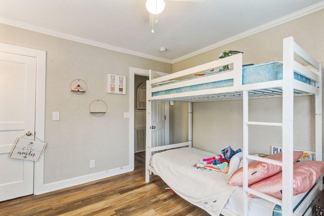 bedroom with crown molding and dark hardwood / wood-style floors