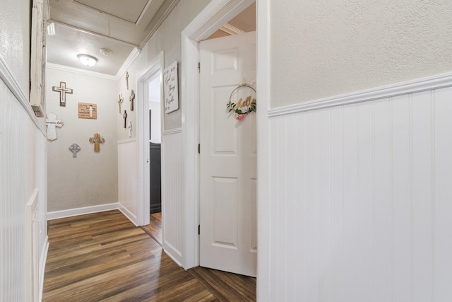 corridor with dark hardwood / wood-style floors and crown molding