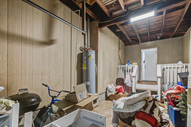 interior space with water heater and wood walls