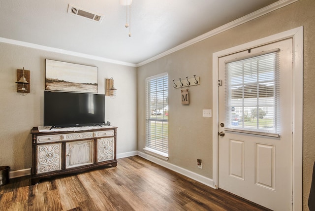 entryway with ornamental molding and wood-type flooring