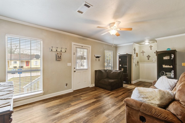 living room featuring ceiling fan, ornamental molding, and hardwood / wood-style floors